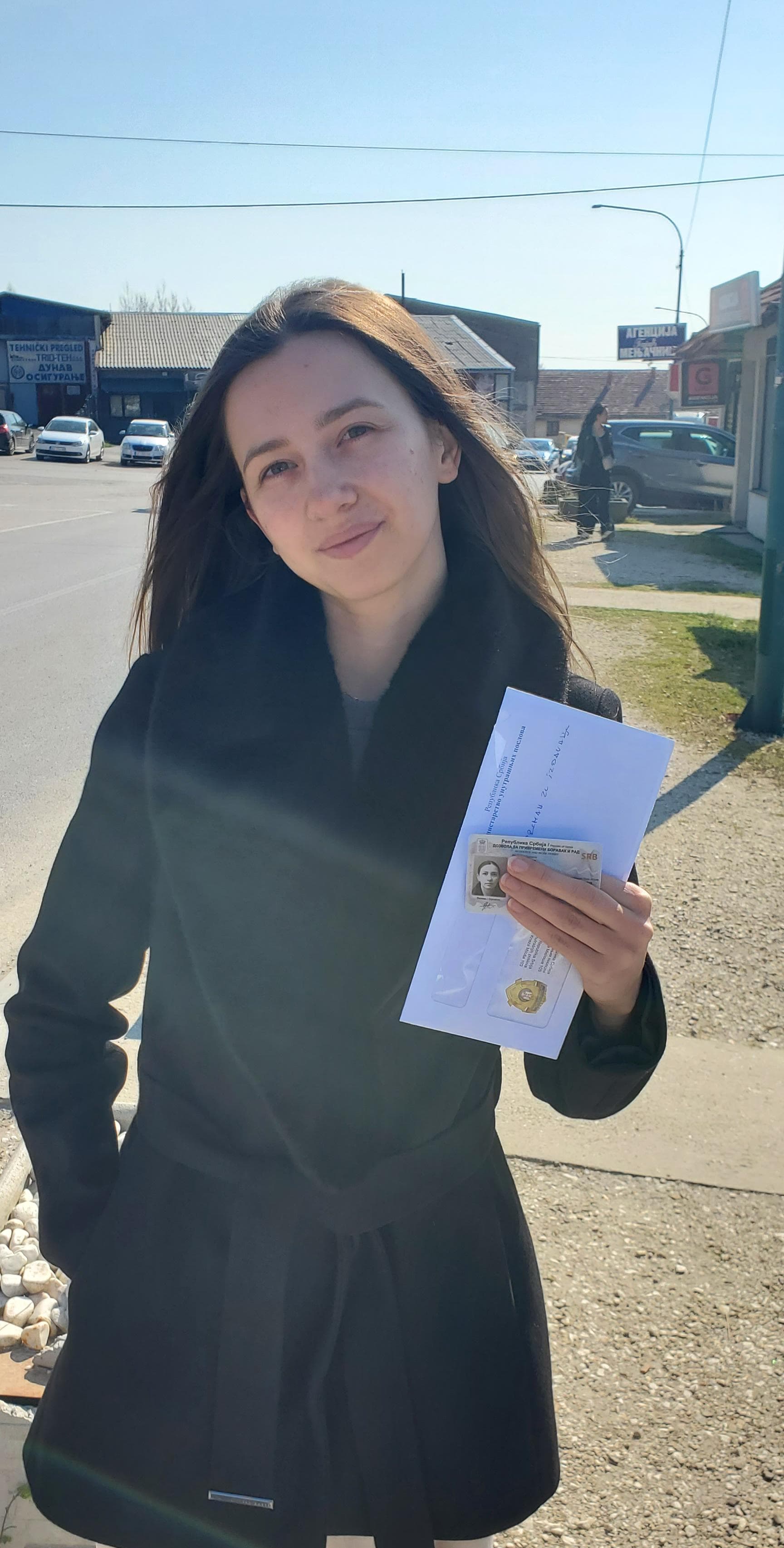 Client holding residence permit documents in Serbia